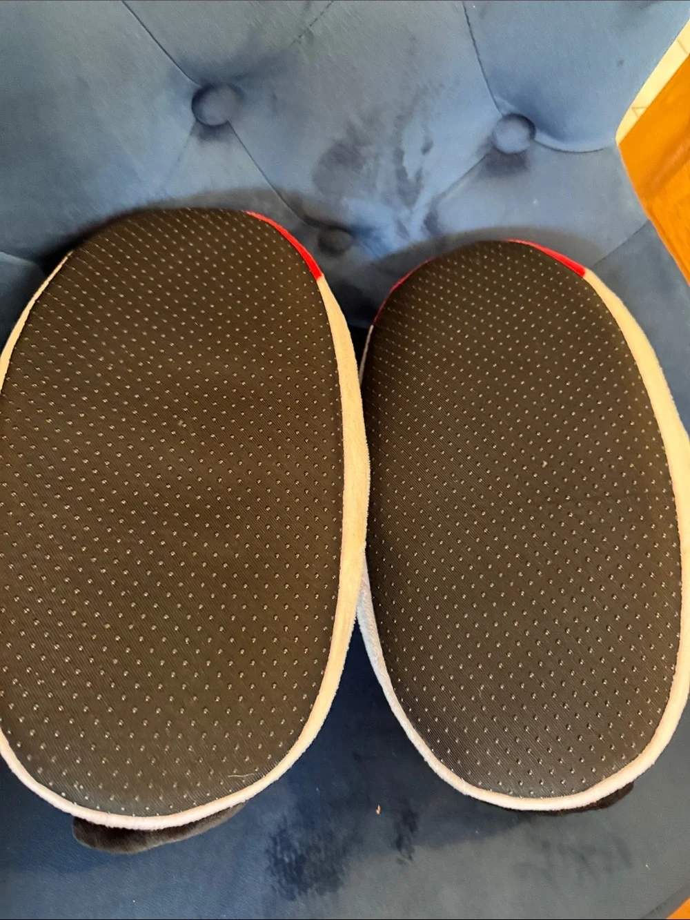 Air Jordan Kids Black and Red fuzzy slippers.